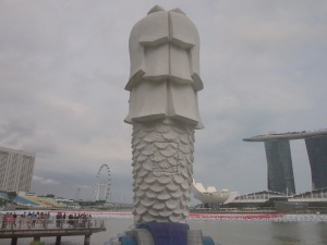 The Merlion stands alone watching the city grows